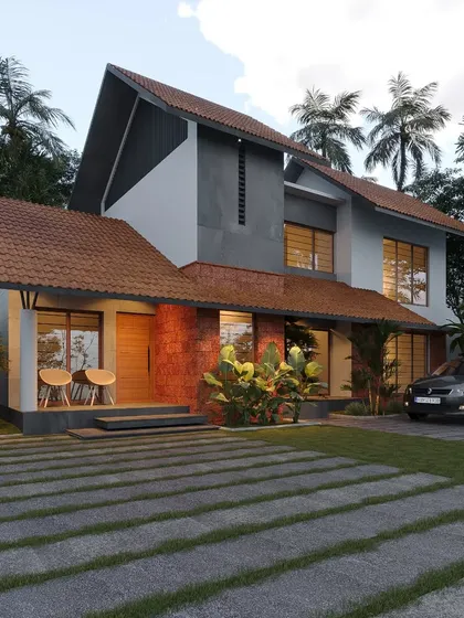 This design uses a mix of laterite brick, concrete, and sloped tile roofing to create a textured and earthy aesthetic that is both modern and traditional.