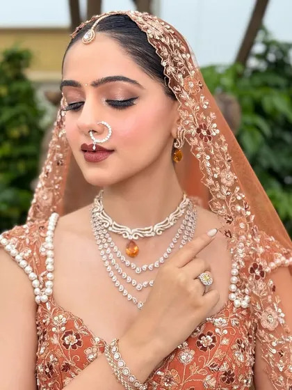 A close-up on the details. This shot highlights the intricate diamond jewelry and how the makeup, especially the defined eyes and lips, works in harmony with the accessories.
