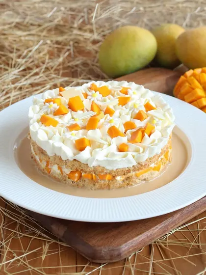 Another view of our Mango Tres Leches, soaking in a pool of sweet milk. It's a perfectly moist and flavorful cake that captures the essence of summer.