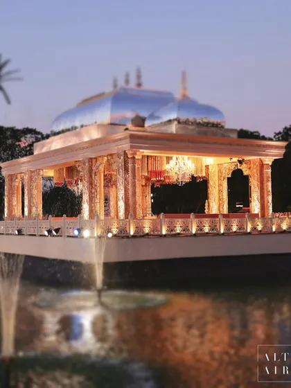 A closer look at the 'Saanjh Niwas' floating mandap at dusk. The reflection on the water and the warm lighting created a truly magical and ethereal atmosphere for the wedding ceremony.