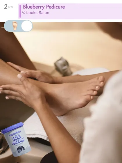 A snapshot of self-care. This image shows a client enjoying our signature Blueberry Ice Cream Pedicure, a treatment designed to soothe and refresh tired feet.