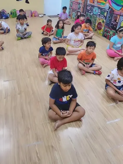 A moment of calm as our youngest students practice simple meditation at the start of their yoga class. Teaching mindfulness early helps build focus and emotional regulation.