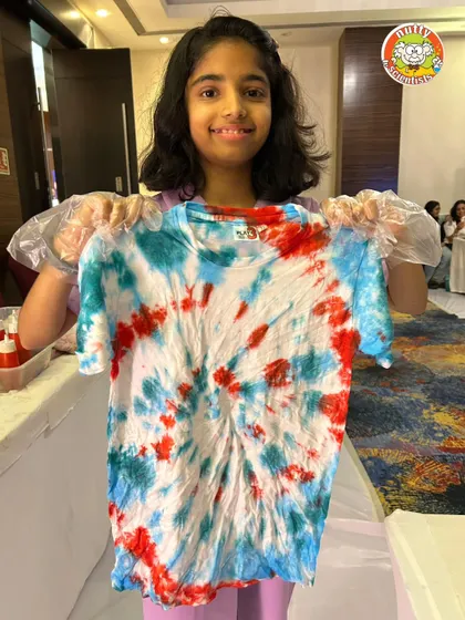 Another fantastic creation from our tie-dye workshop. The pride and happiness on this participant's face says it all. It's a fun, hands-on activity for all ages.