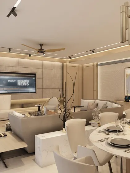 This contemporary living and dining area in a Pune apartment at Hyde Park reflects a deep appreciation for art, design, and elegant simplicity. Elegant wall paneling anchors the space, pulling every element into a cohesive composition of neutral tones and curated artwork.