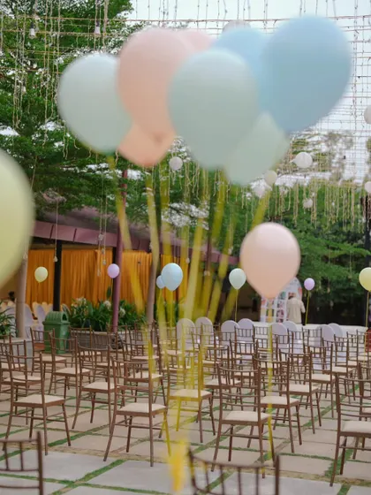 Pastel balloons floating above the seating area at the carnival party. This simple touch added to the light and airy feel of the outdoor celebration.