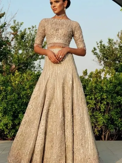 A fully embroidered gold lehenga is a timeless choice for a bride. I can create a similar regal look, ensuring the fit and fall are perfect for you.
