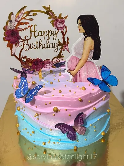 A special birthday cake for a mom-to-be. The pink and blue ombre design is complemented by butterfly accents and a beautiful topper.