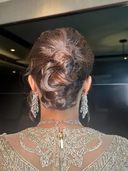 A modern and textured messy bun, perfect for a cocktail party or reception.