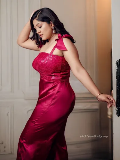 An elegant pose highlighting the silhouette of the jumpsuit.