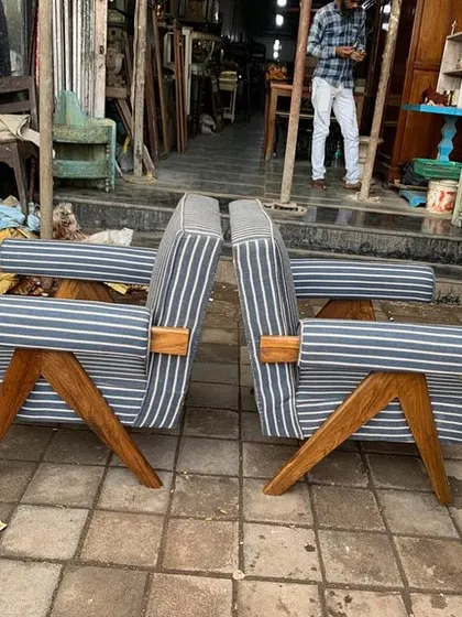 A side profile of the chairs, emphasizing the distinctive Z-shaped frame made from solid wood.