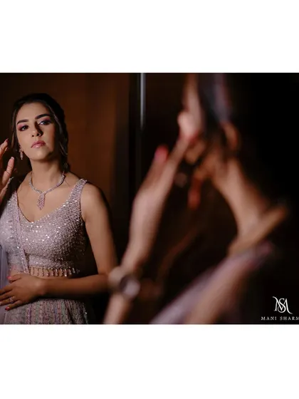 A beautiful getting-ready shot of the bride, Shreya, looking in the mirror before her engagement.