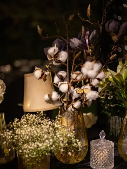 An arrangement featuring dried cotton stems and dark magnolia, offering a unique textural contrast. This is an example of how we push creative boundaries by incorporating unconventional materials into our floral designs.