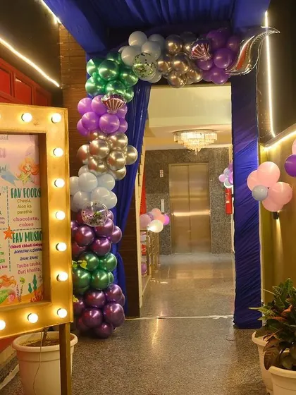 A personalized milestone board with a lighted frame at the party entrance. It's a wonderful way to welcome guests and share fun facts about the birthday child.