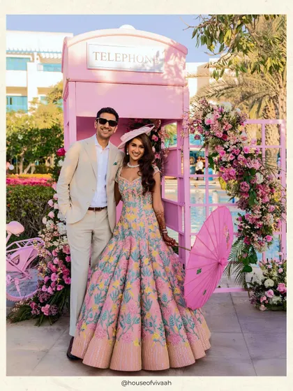 A touch of whimsy for a poolside luncheon. This custom-designed pink telephone booth, framed by florals, became the most beloved photo corner of the event. I believe in adding playful, unexpected elements that spark joy and invite guests to interact with the design.