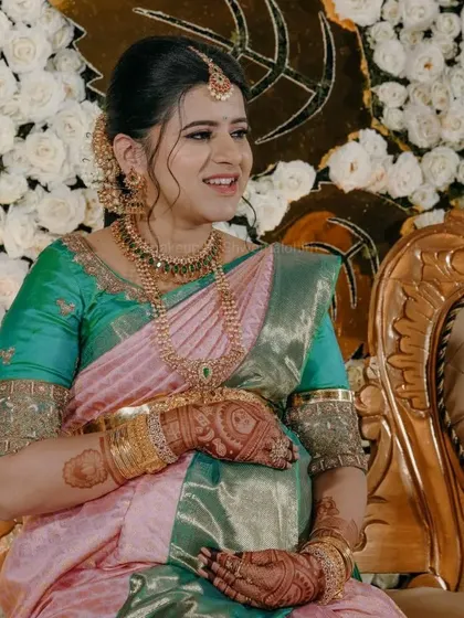 The gorgeous mommy-to-be, Niharika, at her baby shower. She is glowing in a beautiful silk saree, with makeup that is both traditional and radiant.