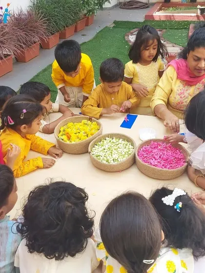 A teacher guides a group of children as they create their floral bookmarks. We encourage creativity while providing support to help their ideas blossom.