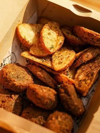 The perfect snack box for a football match. This box contains crispy falafel and seasoned potato wedges, essential components of my Lebanese Platter.