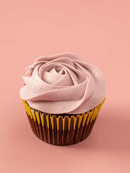 A perfect buttercream rose, piped in a soft lavender hue. This is one of my most popular floral designs, sitting atop a rich and moist egg-free chocolate cupcake.