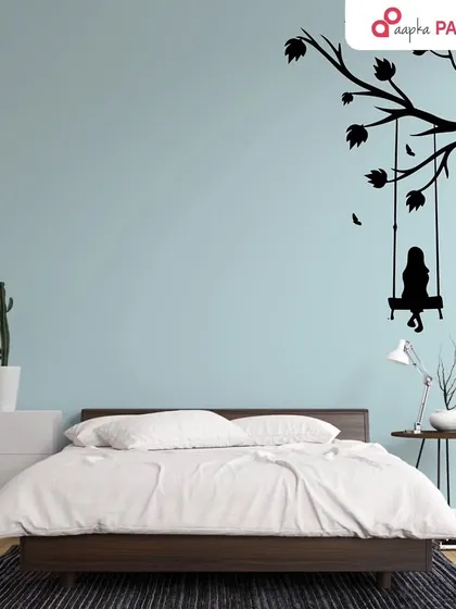 The silhouette of a girl on a swing brings a sense of peace and nostalgia to this bedroom. It's a simple design with a powerful emotional impact.