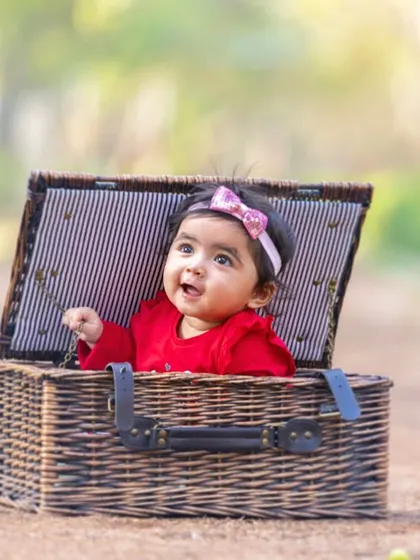 A classic and adorable baby portrait. Using simple props like this vintage wicker basket allows the baby's curious and happy expression to be the star of the photo.