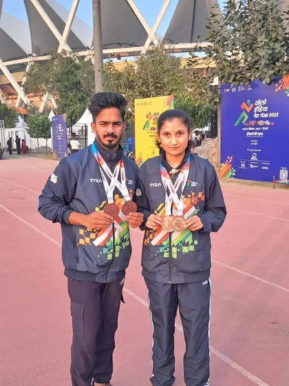 Para-athlete Jyothi and her guide runner Vikram showcasing their bronze medals from the Khelo India Para Games. They competed in the T11 and T12 categories, securing podium finishes in both the 200m and 400m races.