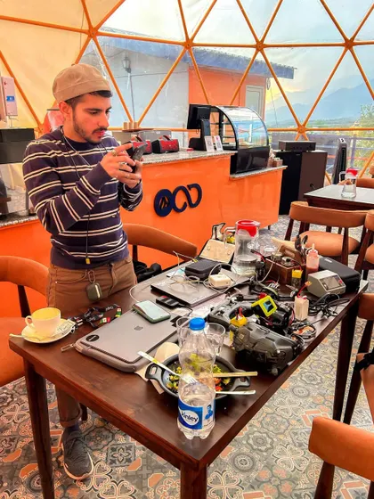 This is the reality of an FPV pilot's workspace. A table full of drones, batteries, laptops, and tools is where the magic is prepped, repaired, and refined.