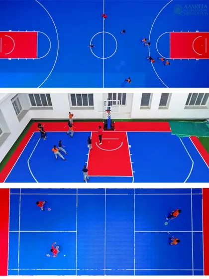 Top-down and angled views of students playing on the indoor basketball and badminton courts at Amrita International Vidyalayam, showcasing the school's sports facilities.