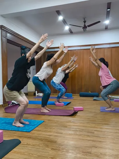 Sunday is for energizing yourself. Students in Utkatasana, or chair pose, building heat and strength together in our weekend class.
