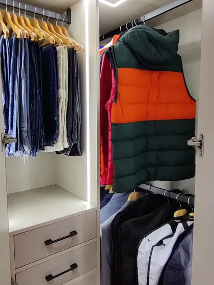 Deep corner cupboards can be tricky, but they are perfect for lesser-used items. Using a hanging rod makes it easy to access jackets and pants without having to dig through stacks on a shelf.