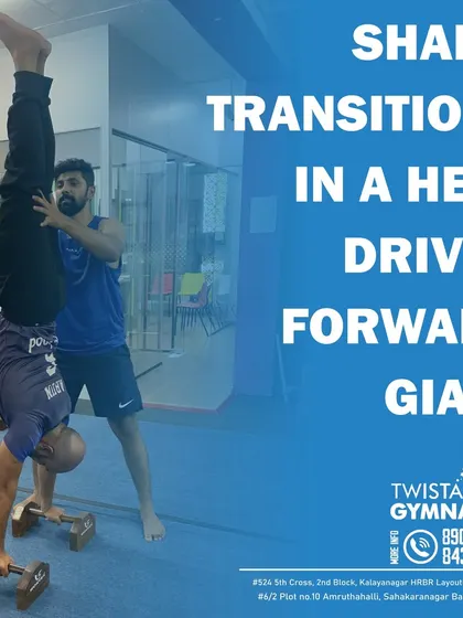 Pushing boundaries with advanced training techniques. Here, a coach assists a student with a weighted handstand to build exceptional shoulder stability and core strength.