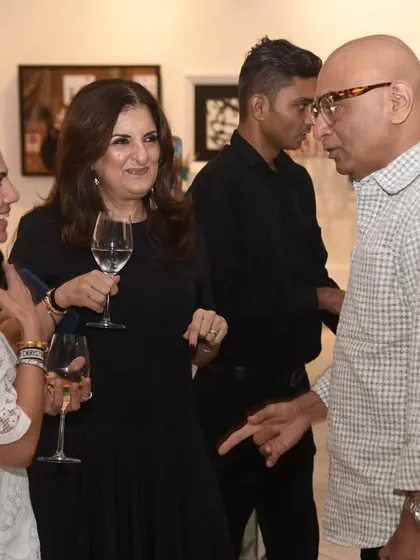 Our founder enjoying a conversation with guests at an opening night. These interactions are key to building a strong community around our gallery and the artists we represent.