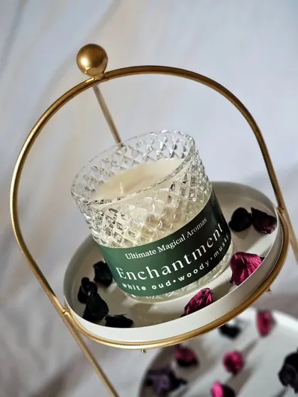 The 'Enchantment' Crystal Jar Candle, featuring a sophisticated blend of white oud, woody, and musky scents. It's one of my personal favorites for an elegant ambiance.