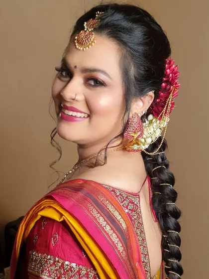 A beautiful smile from this happy bride, Archana, during her Varapooje ceremony. Her look is completed with a traditional braided hairstyle adorned with fresh flowers and hair accessories.