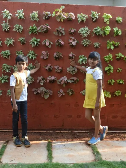 Another view of the completed vertical garden with the children who will get to enjoy it every day. This is a practical and beautiful solution for urban gardening.