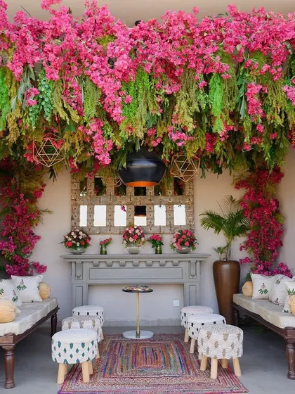 This floral paradise for a mehendi was inspired by Udaipur's local heritage, featuring a cozy seating area under a canopy of flowers.