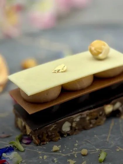 Our Chocolate and Nuts Mille Feuille is a construction of flavour. Layers of nutty crunch, milk chocolate, dark chocolate, and white chocolate offer a complex and satisfying dessert experience.