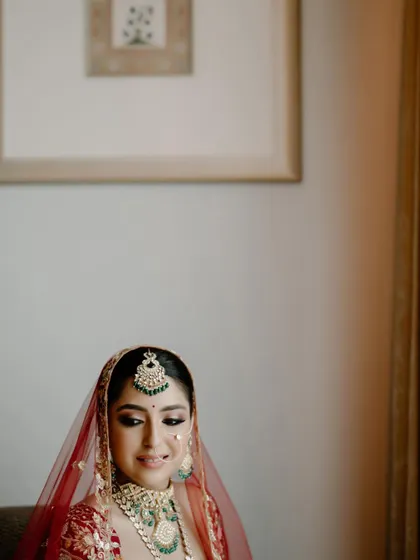 A candid moment of happiness. Even in a relaxed pose, her bridal makeup looks impeccable and radiant.