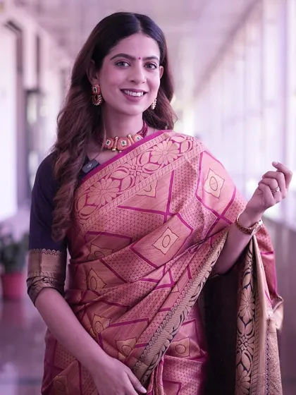 A beautiful pink and gold silk saree. This traditional look is ideal for cultural events or formal ceremonies, radiating grace and elegance.