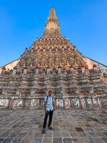 Standing in front of the magnificent Wat Arun, also known as the Temple of Dawn. It's one of the most iconic landmarks in Bangkok.