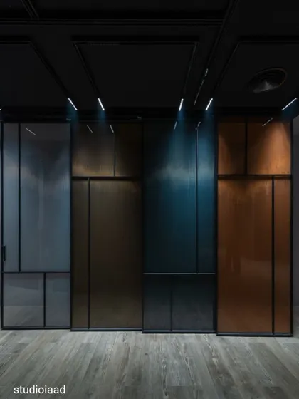 The experience center for JB Glass in Daulatabad uses a dark, immersive theme to highlight the product. The interplay of focused lighting on various glass finishes and textures creates a memorable walk-through where the material itself is the main attraction.