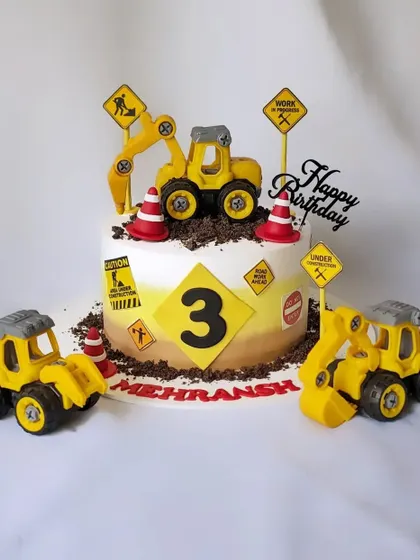 Let's get digging! This construction theme cake is perfect for a 3rd birthday, complete with edible dirt, construction signs, and toy excavators.