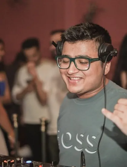 Spreading good vibes from the DJ booth. A simple shaka sign to connect with the crowd.