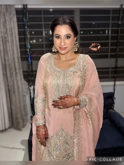 The complete look is graceful and timeless. The hairstyle adds a touch of modern elegance to her traditional attire.