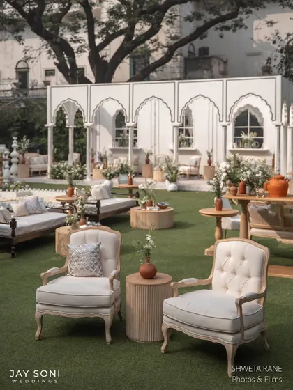 A wider view of the ivory lounge, showcasing the variety of seating options from plush armchairs to comfortable daybeds, all arranged to encourage guest interaction.