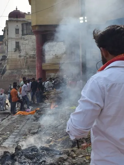 A scene from the Manikarnika Ghat in Banaras during Pitrpaksh. I document these profound rituals of life and death from a distance, capturing the smoke, the crowd, and the solemn atmosphere of moksh.