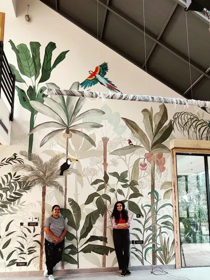 My painting partner and I in front of the massive rainforest mural. This project was a true test of our skills and teamwork.