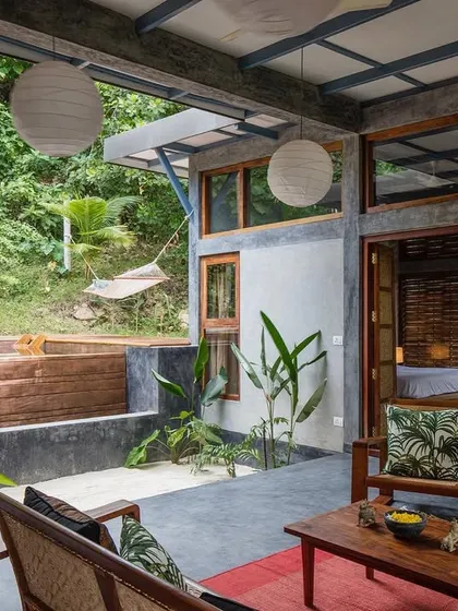 The open-air living room of the Jalakara villa, complete with a hammock and views of the plunge pool and jungle.