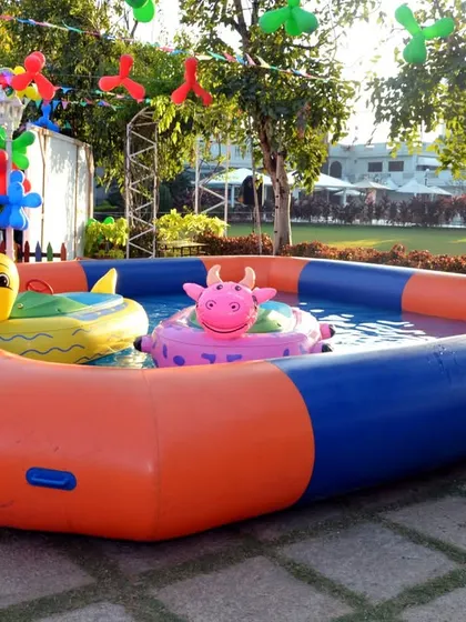 An inflatable pool with cute animal floaties, adding a fun water play element to an outdoor Angry Birds party.