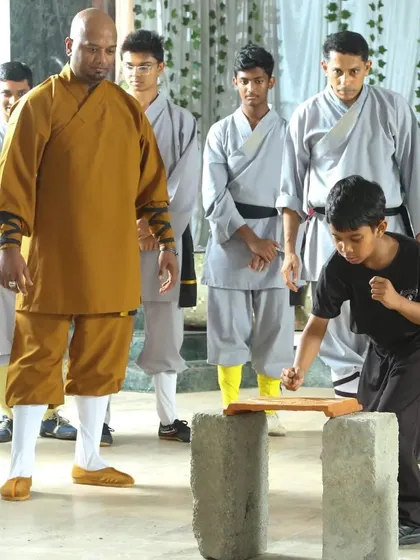 Another angle of the board-breaking demonstration during our black belt ceremony. This is a significant milestone, proving a student's mastery over their mind and body.