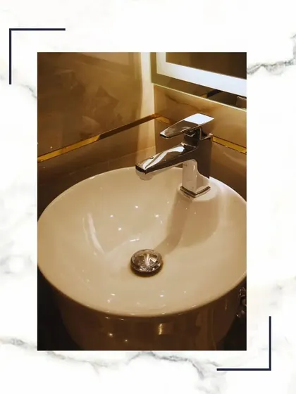 A close-up of a high-quality faucet and vessel sink, showcasing the refinement we bring to every corner of our homes.